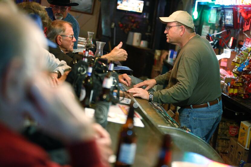 Kenny Sulak (right) talks to a customer at the downstairs bar in Tom Sefcik Hall in Seaton...