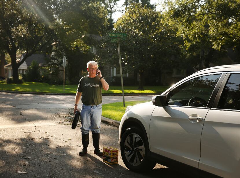 Jon Gjertsen, whose home sustained 4 to 5 inches of water damage, prepares supplies for his...