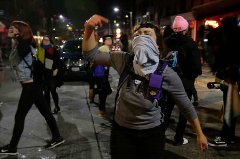 A woman yells as she takes part in a protest against President-elect Donald Trump,...