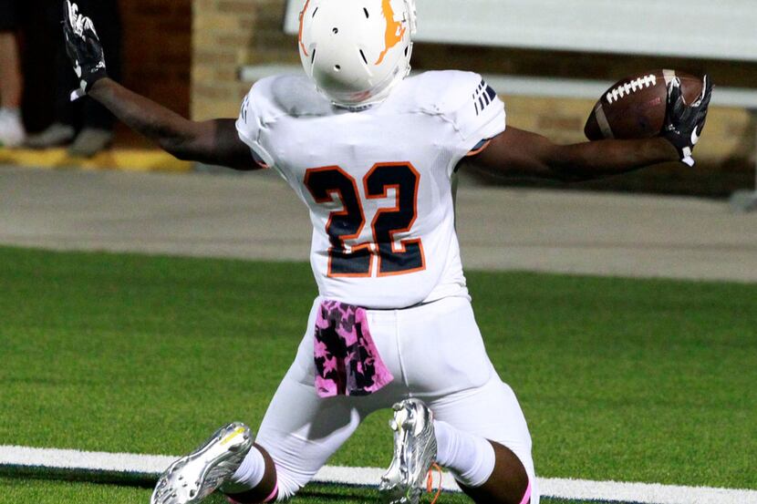 Sachse running back Matthew Carter (22) celebrates in the end zone after scoring during the...
