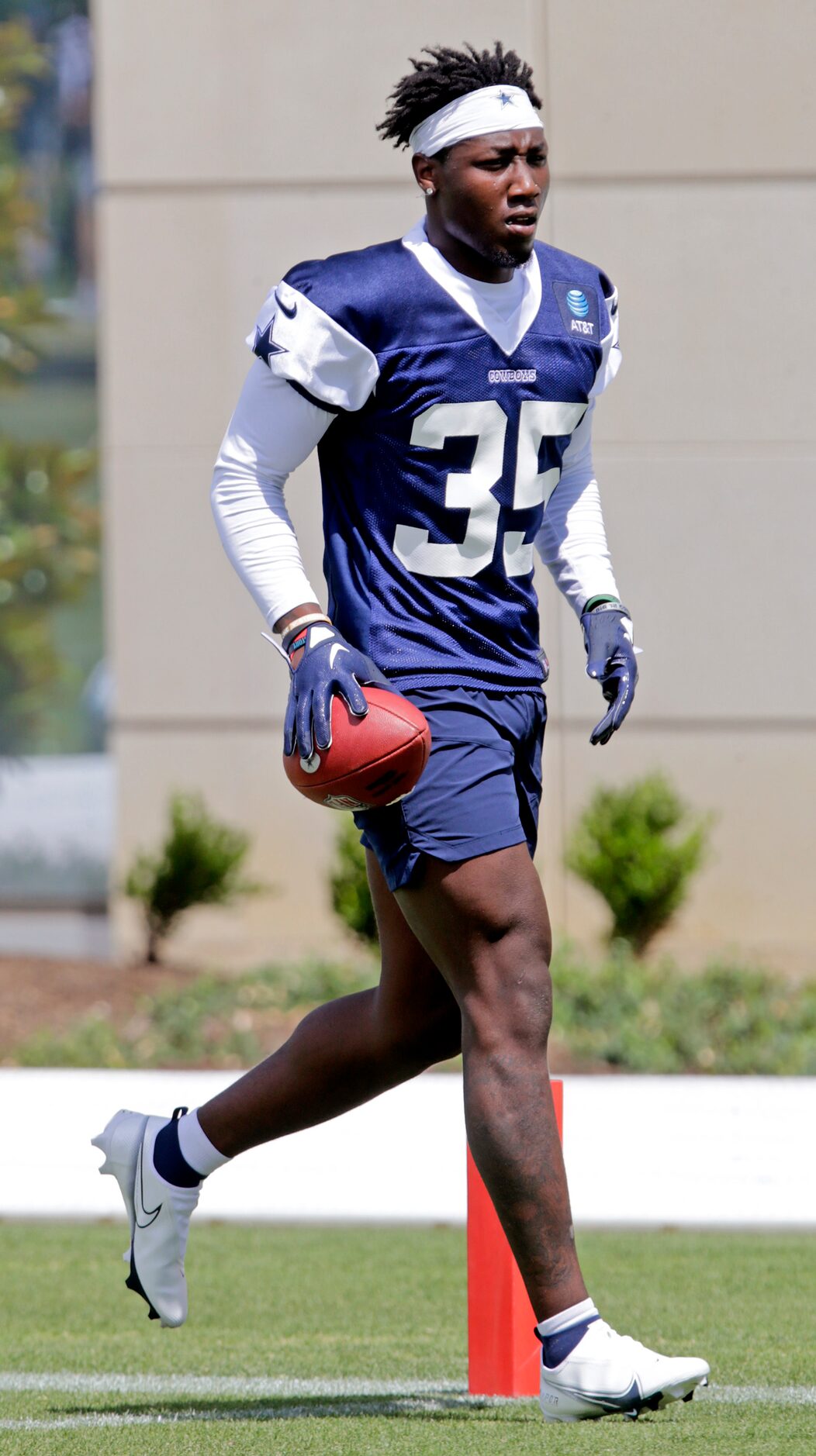 Cowboys rookie linebacker DeMarvion Overshown (35) runs the ball back during a drill as the...