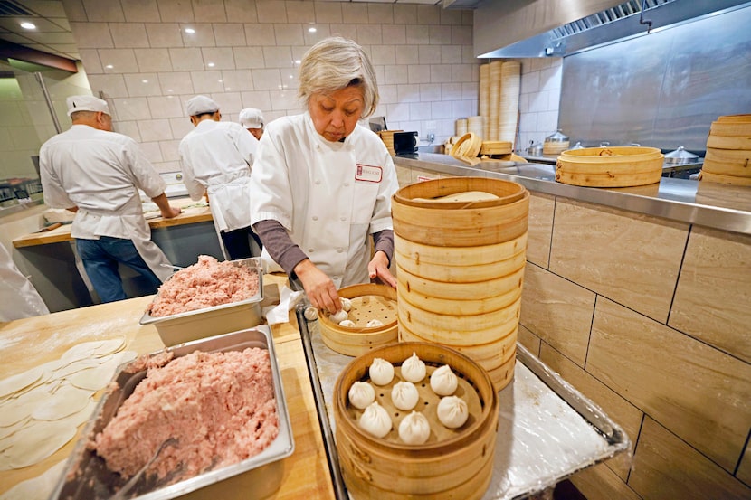 Jeng Chi restaurant co-founder Mei Teng makes pork steamed dumplings at her restaurant,...