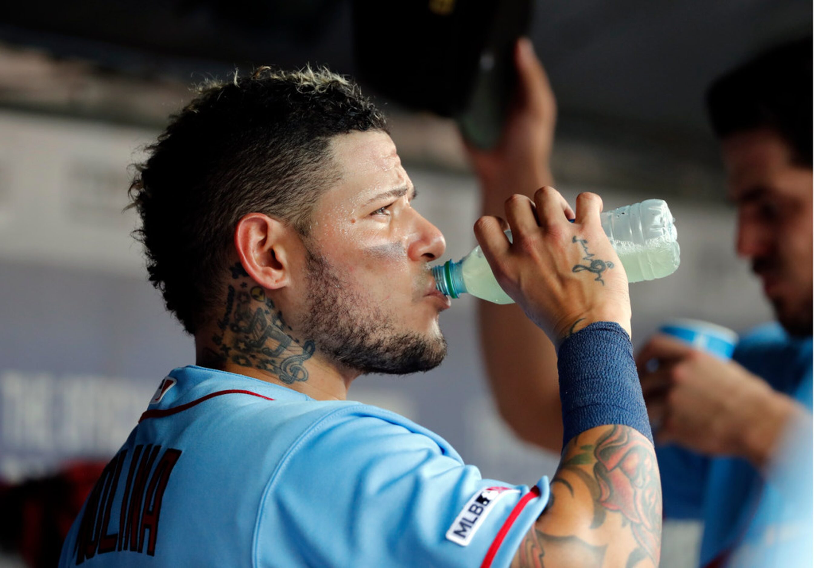 St. Louis Cardinals' Yadier Molina takes a sip in the dugout in the fourth inning of a...