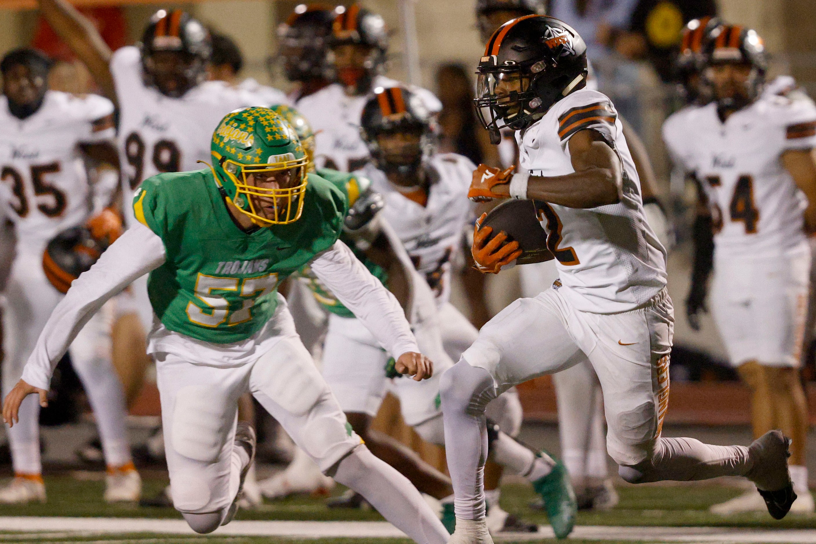 West Mesquite's Greg Gipson (2), right, carries the ball after intercepting a pass as Newman...