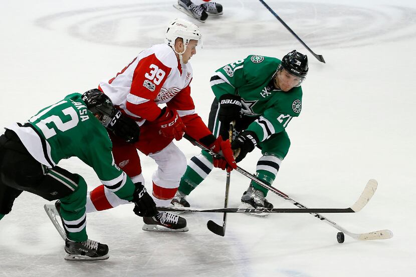 Detroit Red Wings right wing Anthony Mantha (39) is defended by Dallas Stars center Radek...