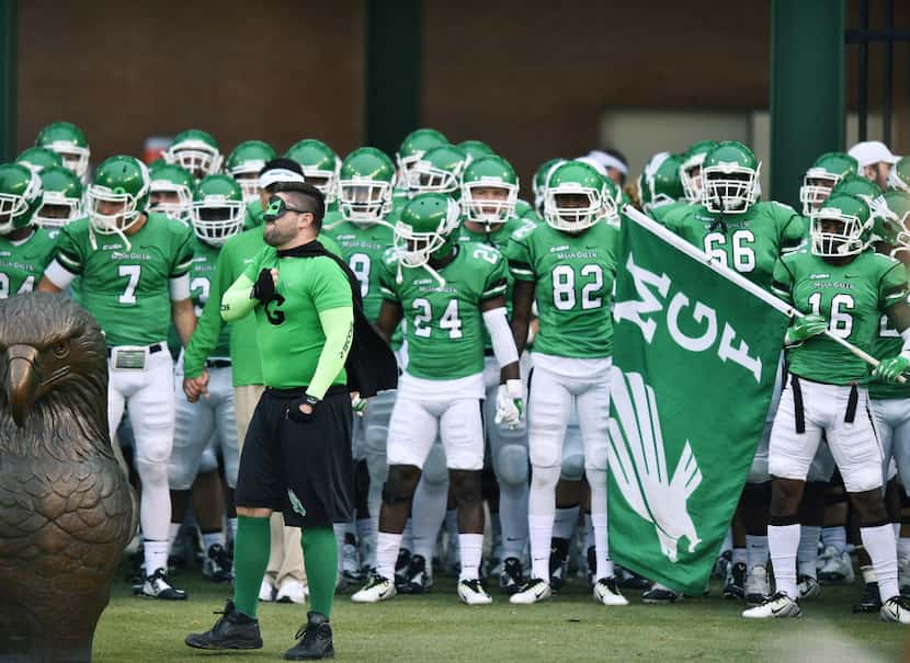 Mean Green Man pounds his chest before the team takes the field North Texas against...