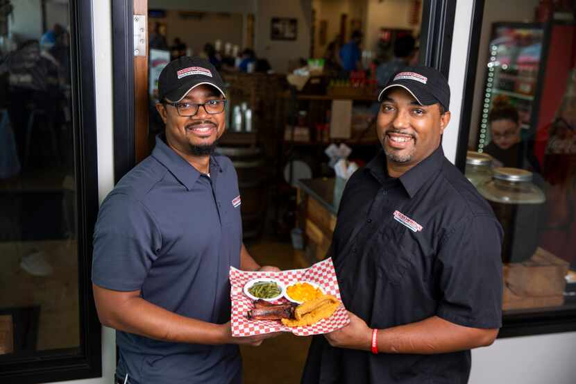 Brent (left) and Juan Reaves hold The Steve White, which is two catfish fillets, two ribs,...
