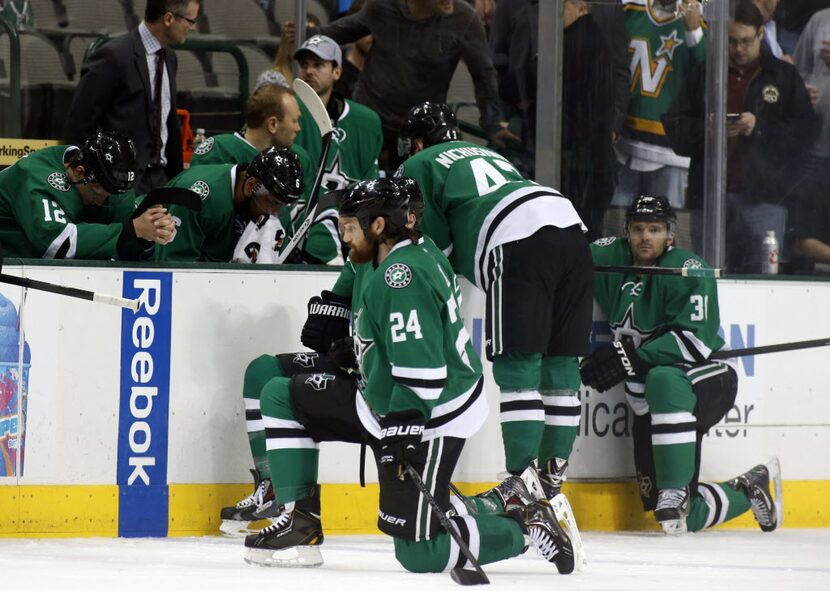 Dallas Stars right wing Alex Chiasson (12) bows his head on the bench as defenseman Jordie...