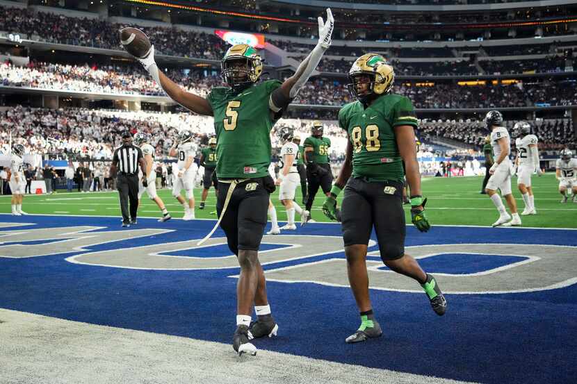 DeSoto running back Tre Wisner (5) celebrates after a touchdown during the first half of the...