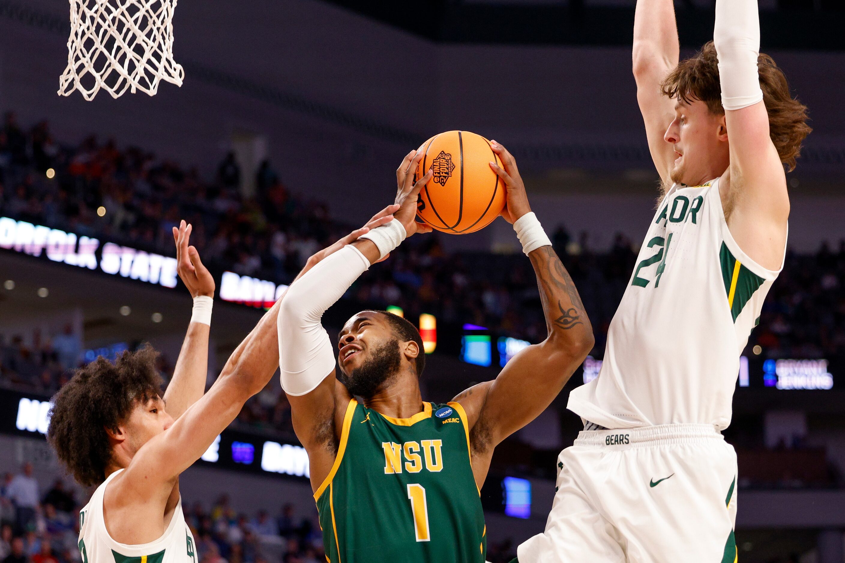 Norfolk State Spartans forward Nyzaiah Chambers (1) drives to the basket between Baylor...