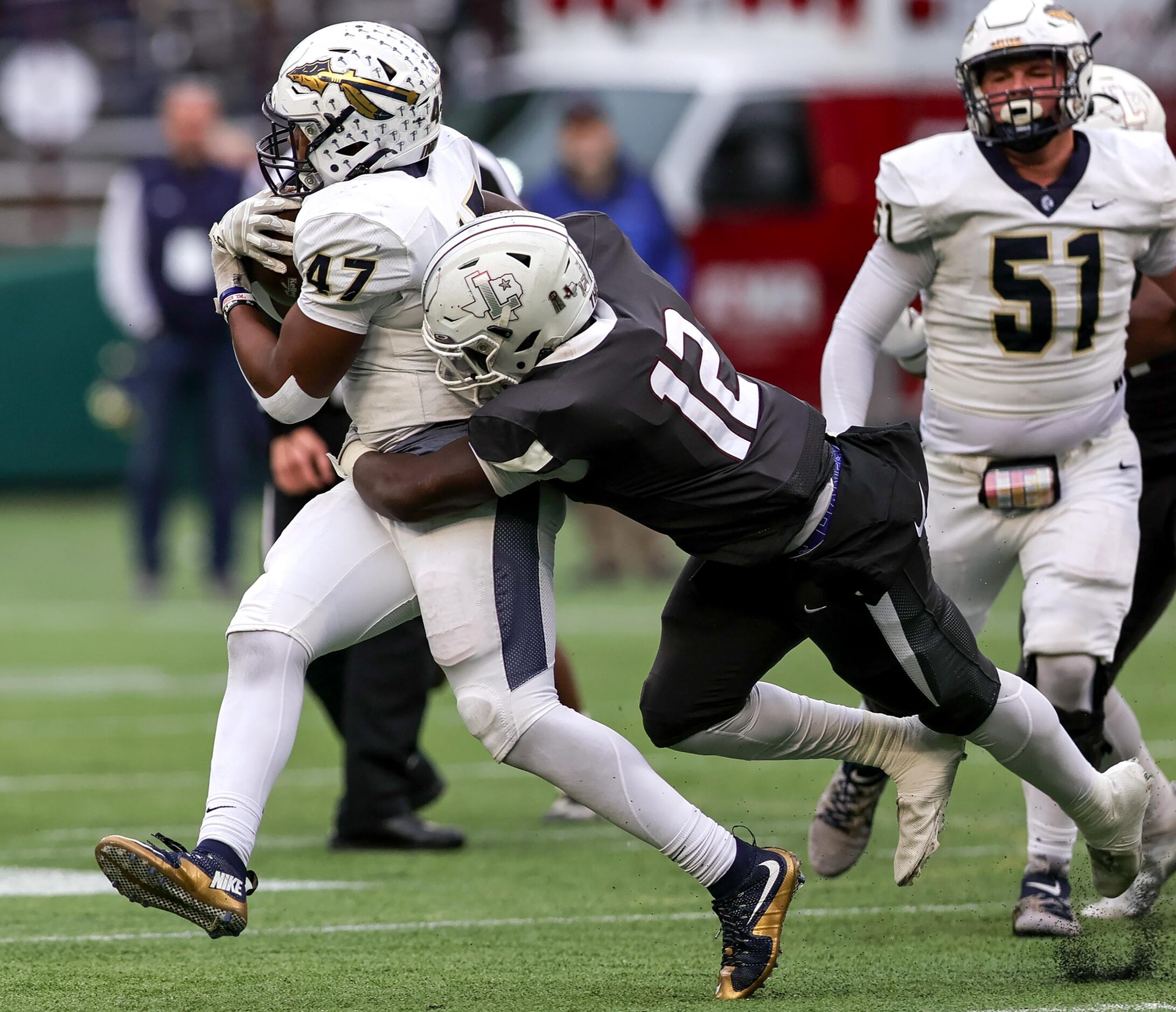 Keller running back Jayden Hart (47) finds a little running room and is brought down by...