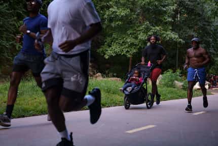 Runners with the group Run it Up make their way through the Katy Trail in Dallas, Texas on...
