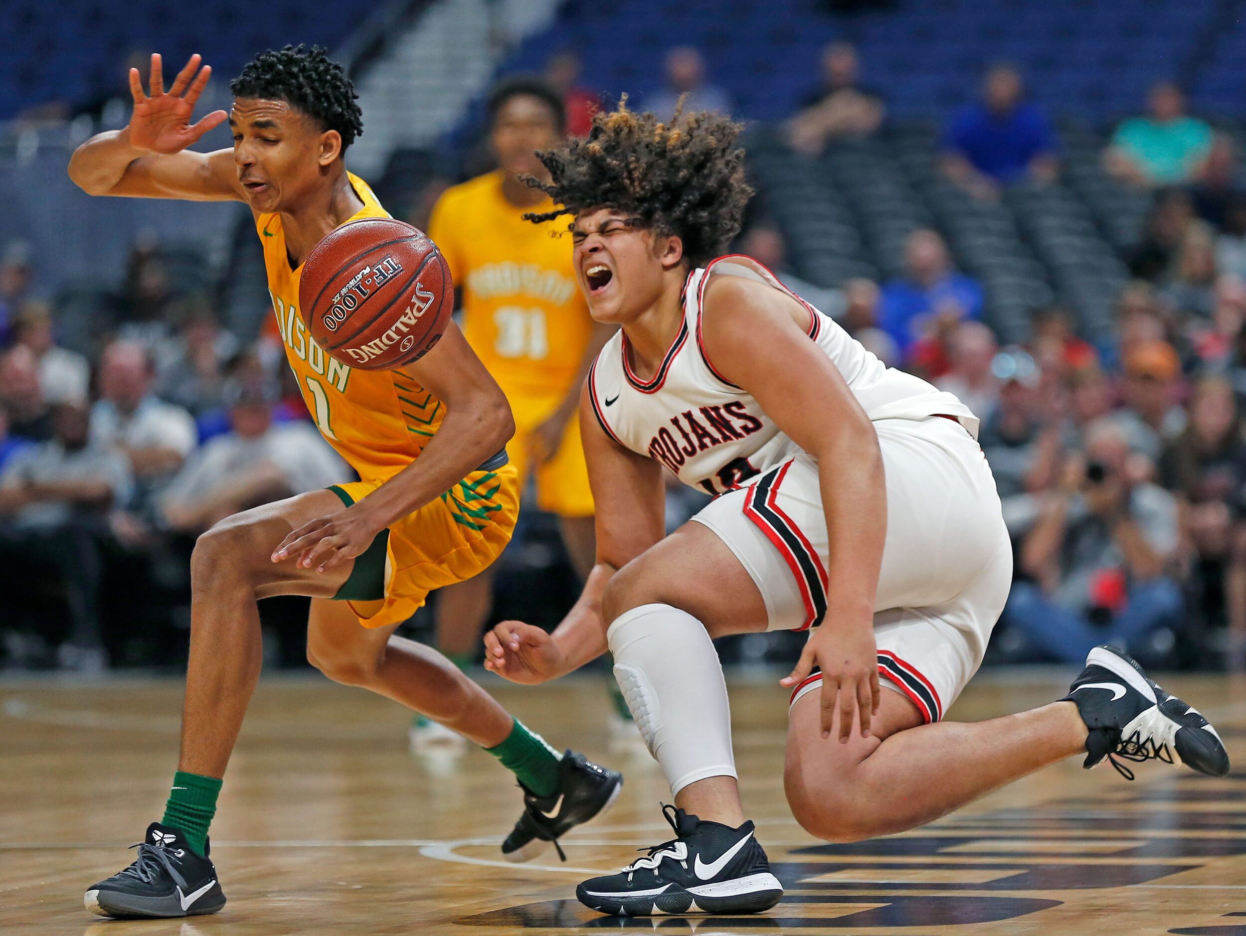 Madison guard Jerome Rogers Jr. #11 steals the ball from Coldspring Jacory Bishop #13 in a...