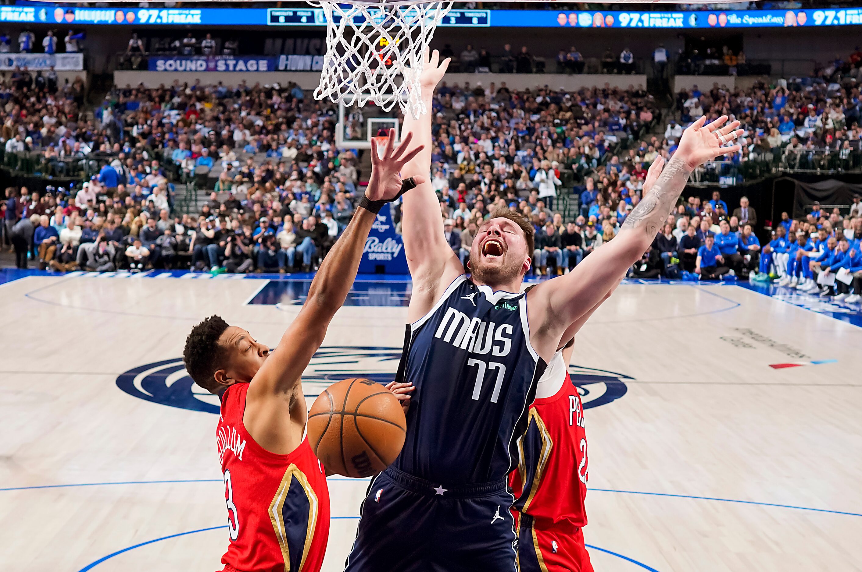 Dallas Mavericks guard Luka Doncic (77) is fouled by New Orleans Pelicans forward Naji...