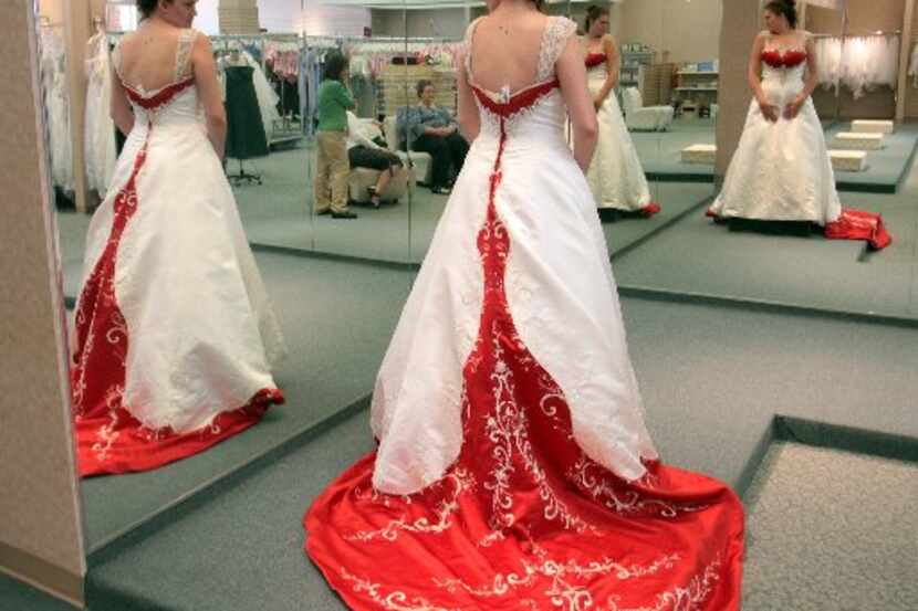 ORG XMIT: *S1949B826* Shannon Lees (cq), tries on one of many wedding dresses at Alfred...