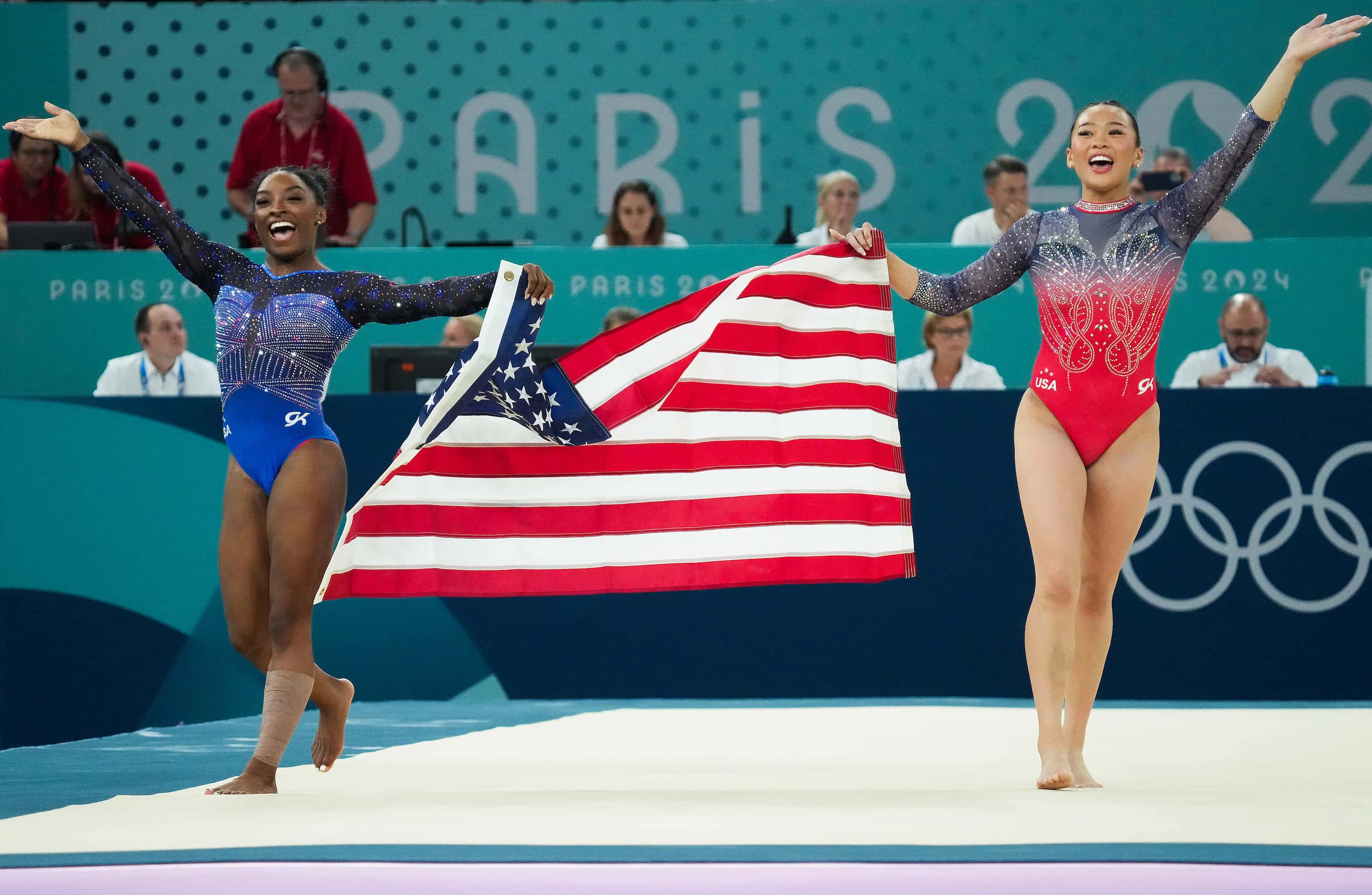 Simone Biles (left) and Suni Lee of the United States celebrate after winning the gold and...