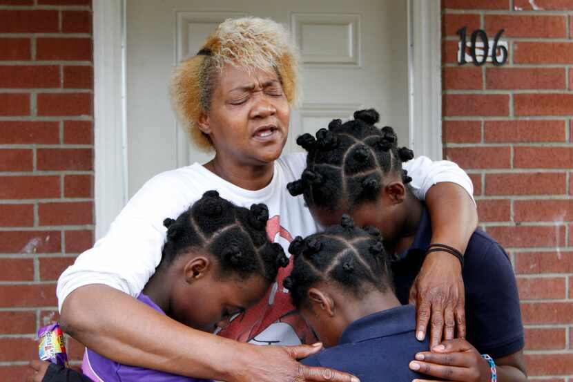 Paula Wooten prays with her grandchildren, A'avryanna Wooten, 10 (left);  I'ivryanna Wooten,...