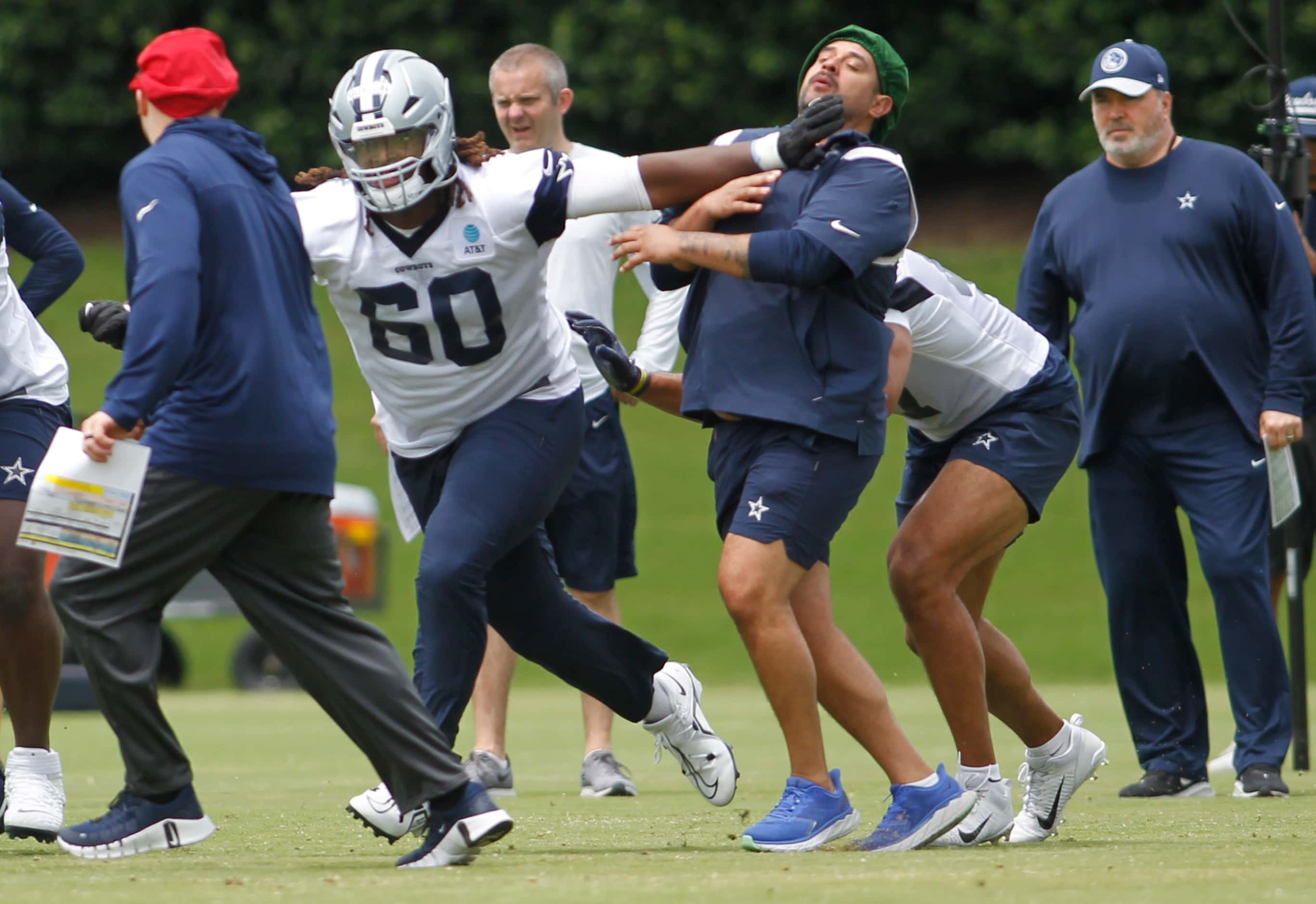 A Dallas Cowboys staff member catches some push back as Cowboys first round draft pick Tyler...