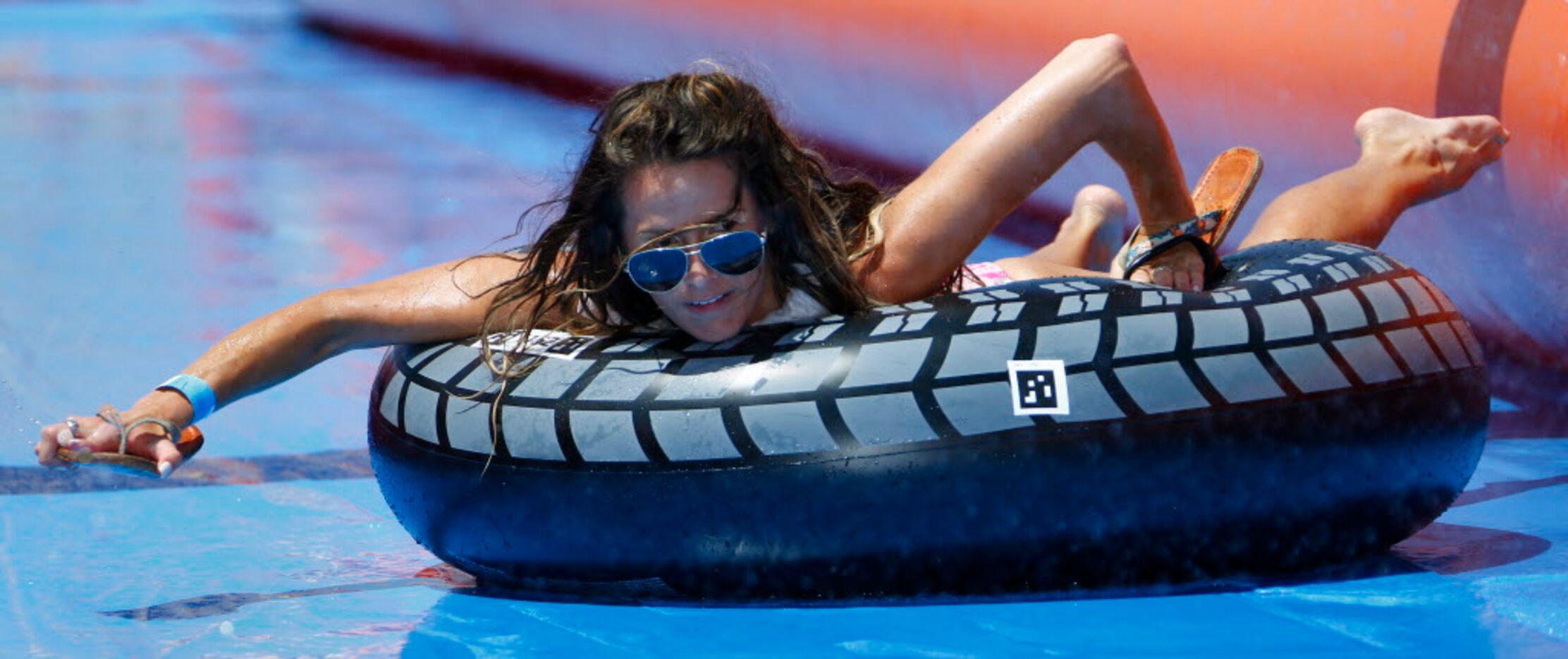 A participant slides on inner tubes down The Urban Slide, a 1,000 foot slide on Sylvan...