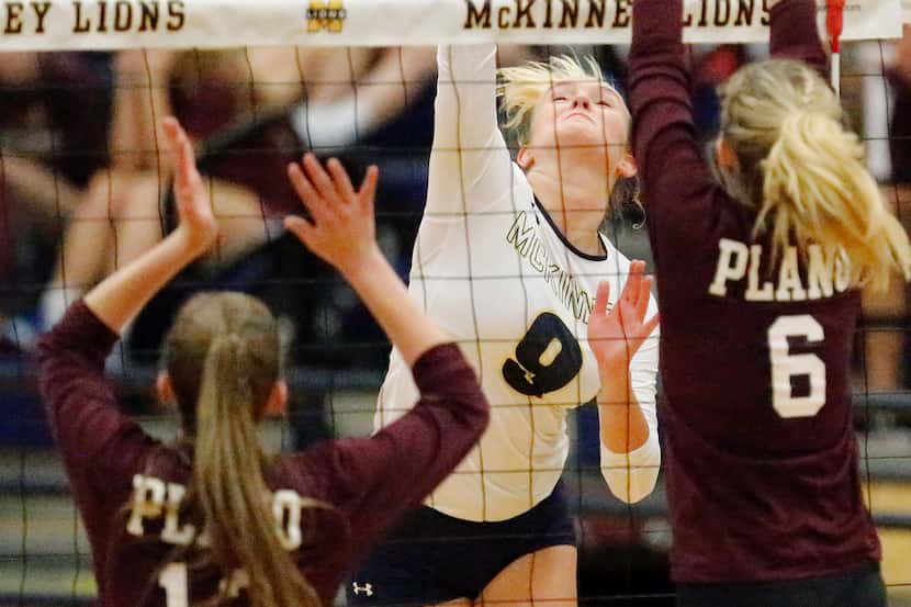 Sophie Manson (9) hits between Plano's Sophie Robinson (13) and Faith Panhans (6) during...