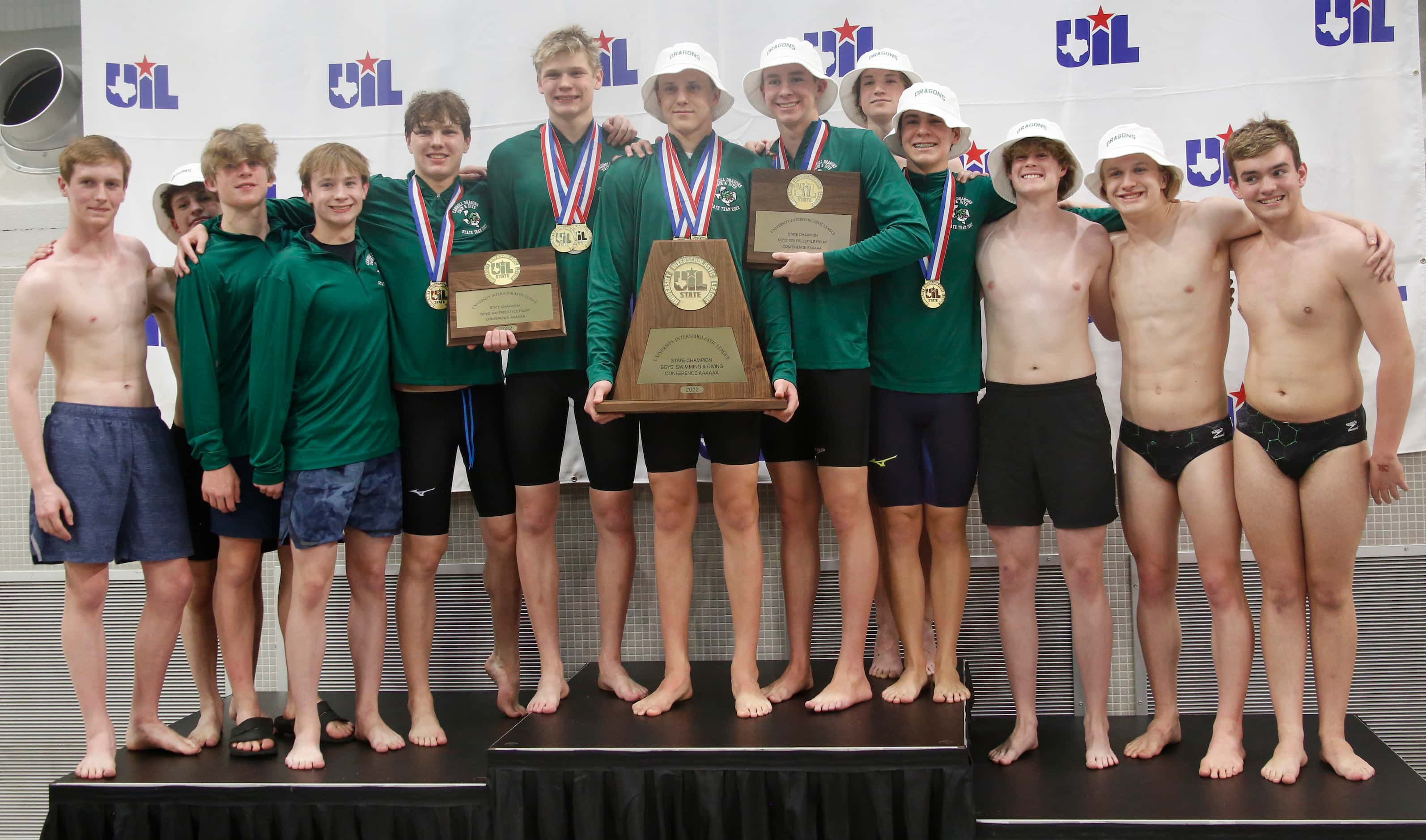 Members of the Southlake Carroll boys swim and dive team pose with their achievements...