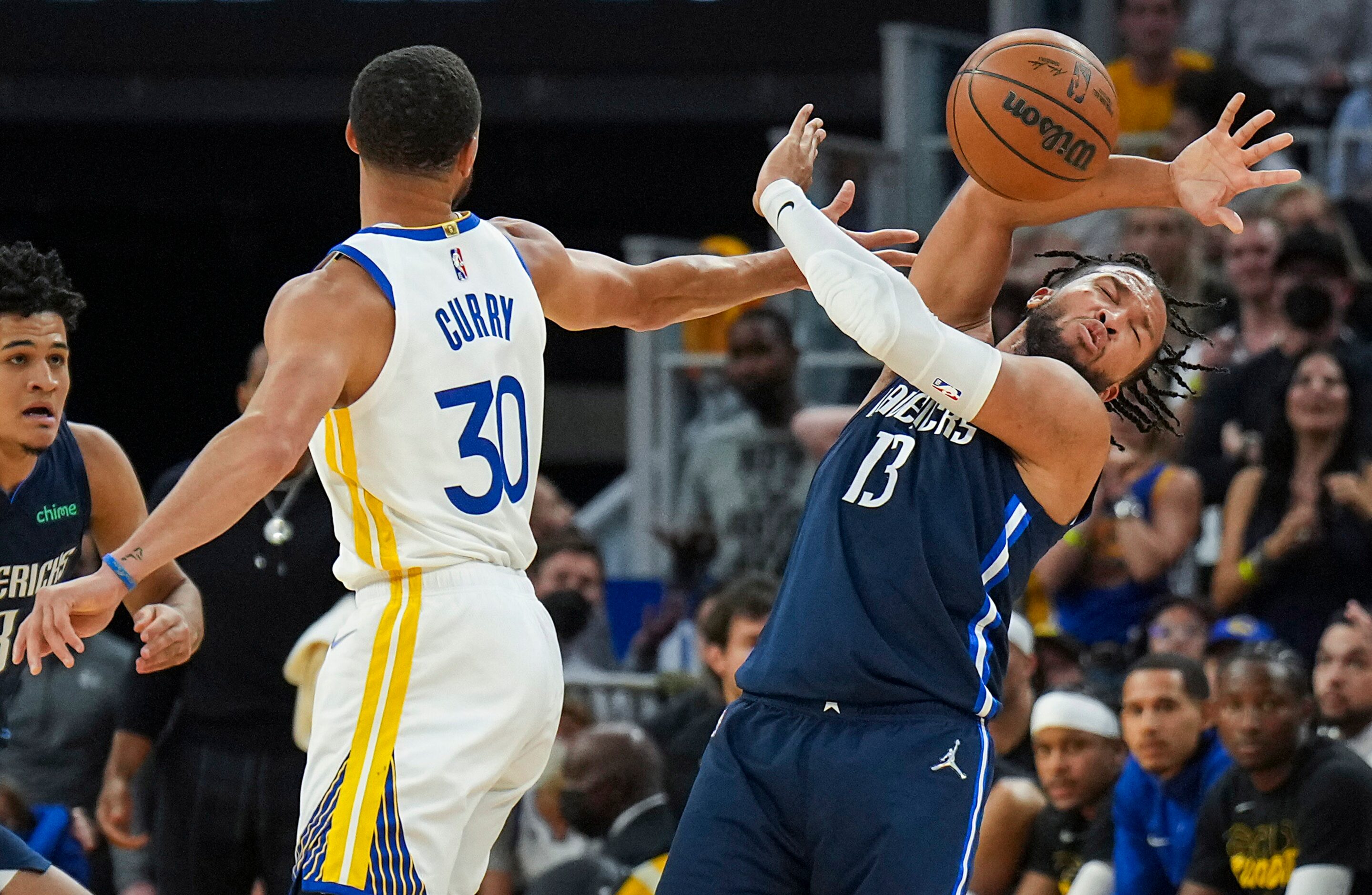 Dallas Mavericks guard Jalen Brunson (13) is fouled by Golden State Warriors guard Stephen...