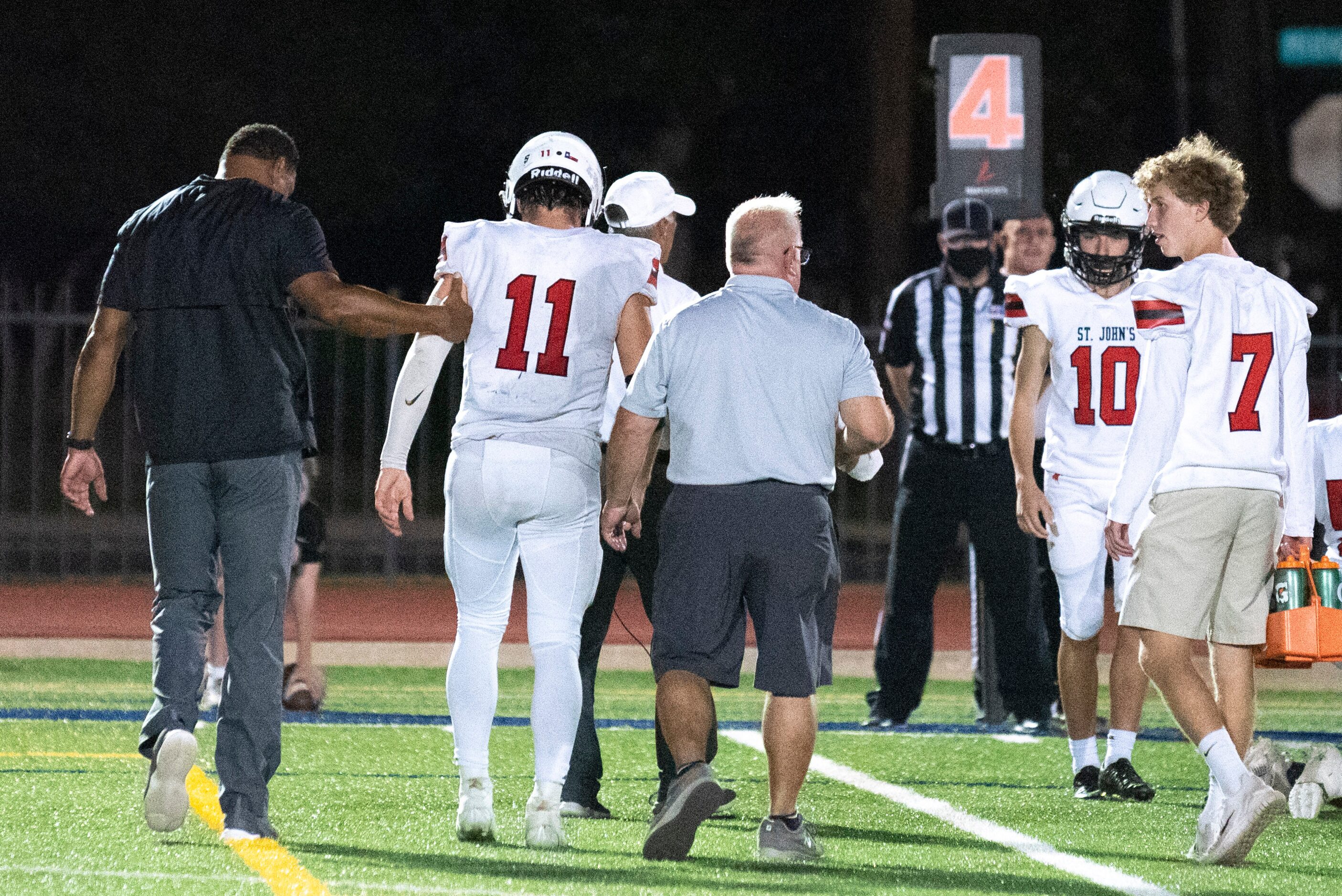 Houston St. Johns senior quarterback John Perdue (11) walks toward the sidelines with...