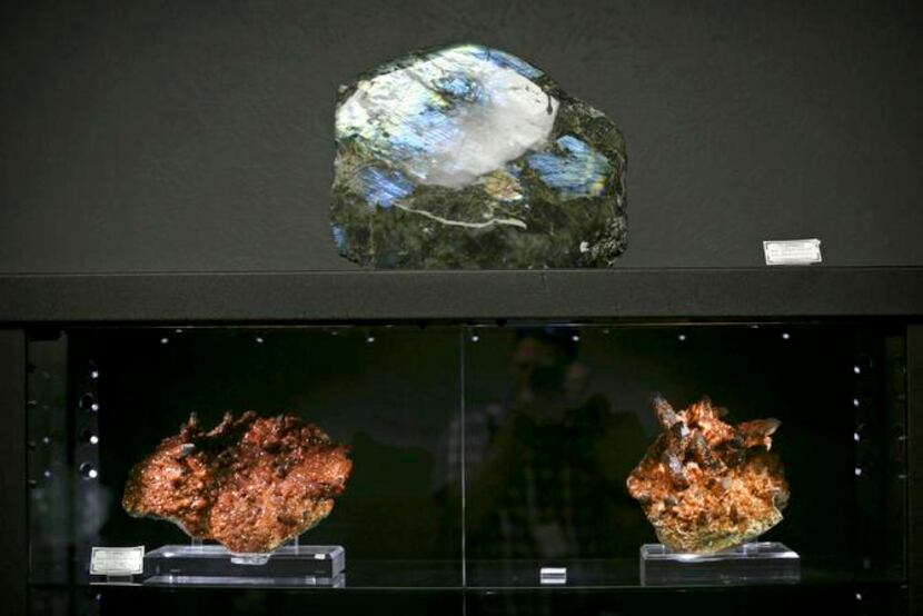 
A labradorite specimen (top) is displayed above a spessartine (bottom left), a form of...