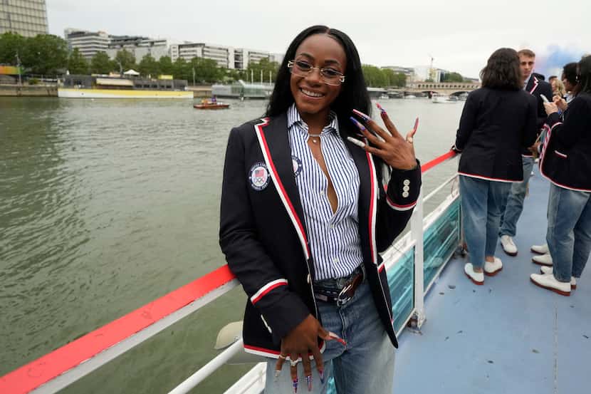 Sha'Carri Richardson poses for a photo while riding on a boat with teammates along the Seine...