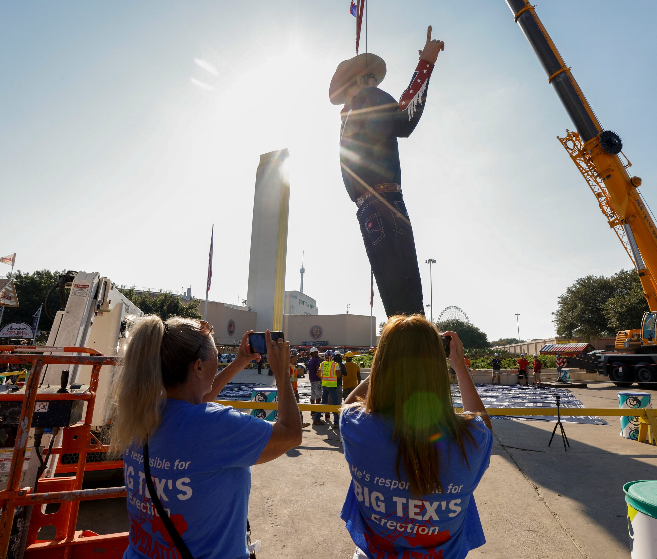 Morgan Kolanek, 17 (right), records a video as her father and crane operator Joe Kolanek...