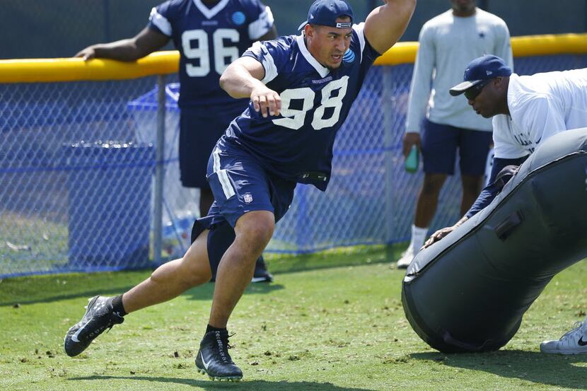 Dallas Cowboys defensive tackle Tyrone Crawford (98) runs through a pass rush drill during a...