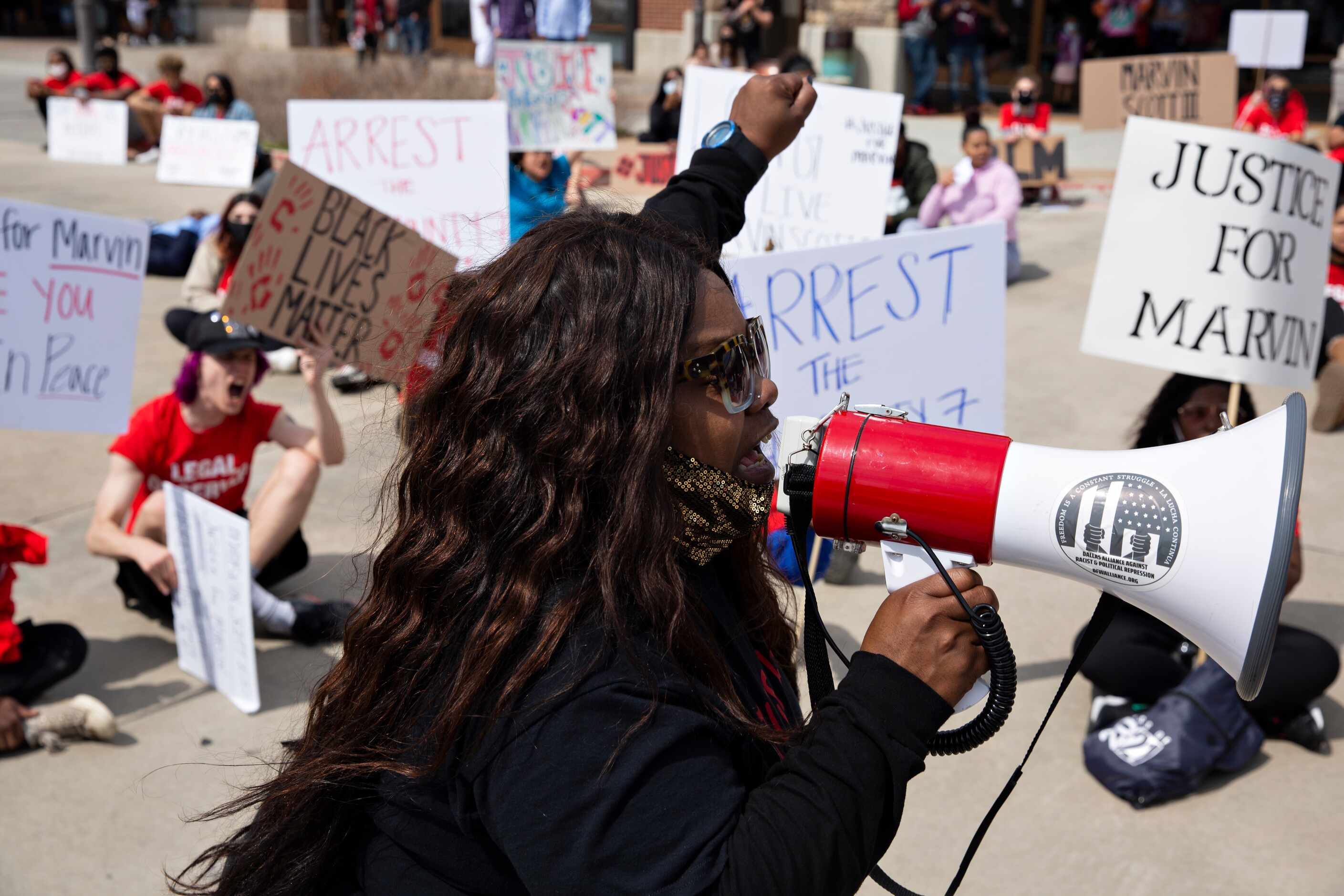 LaSandra Scott leads a chant in the Allen Outlets on Sunday, March 21, 2021 demanding...