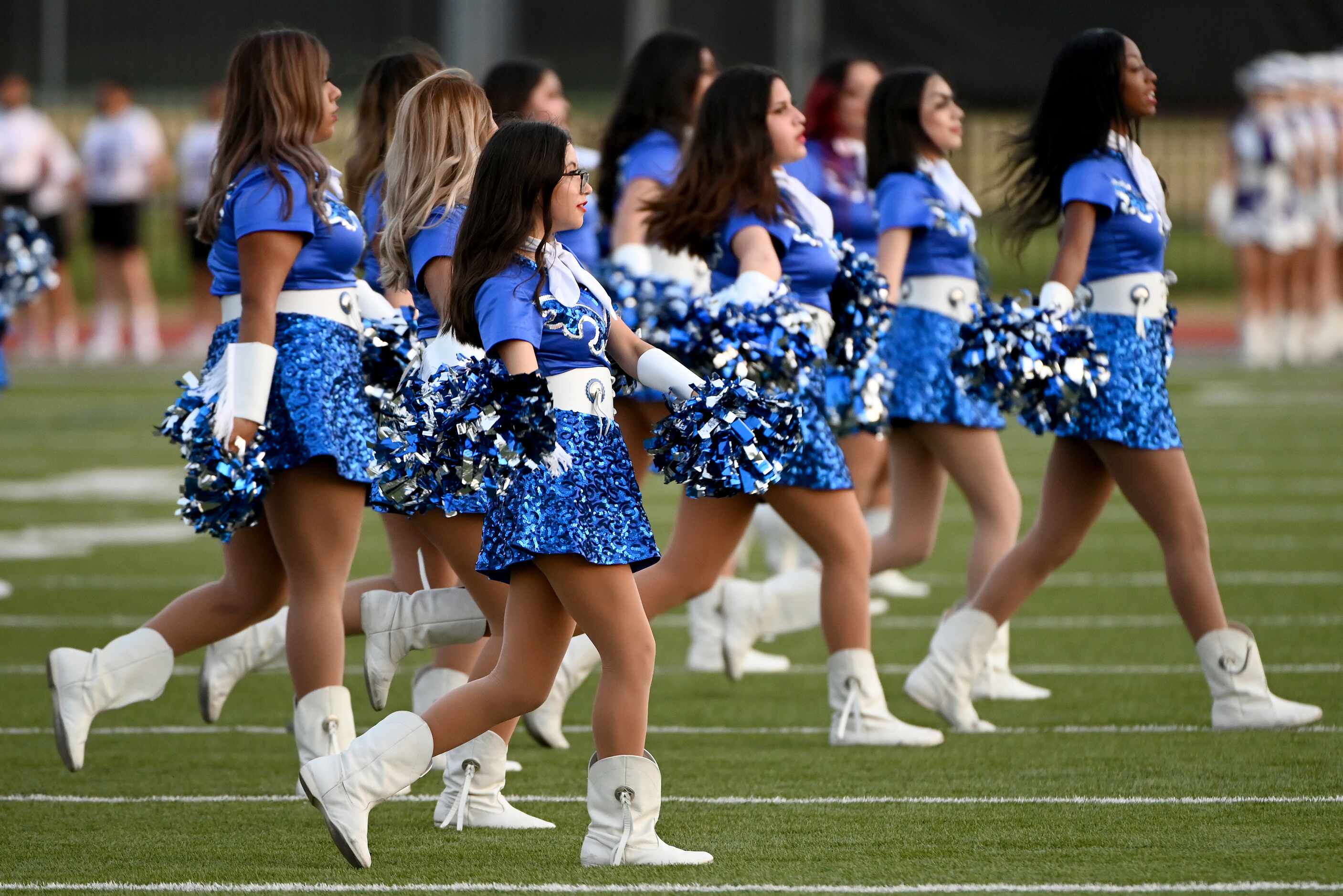 The Adamson Leopardettes perform at halftime during a high school football game between...