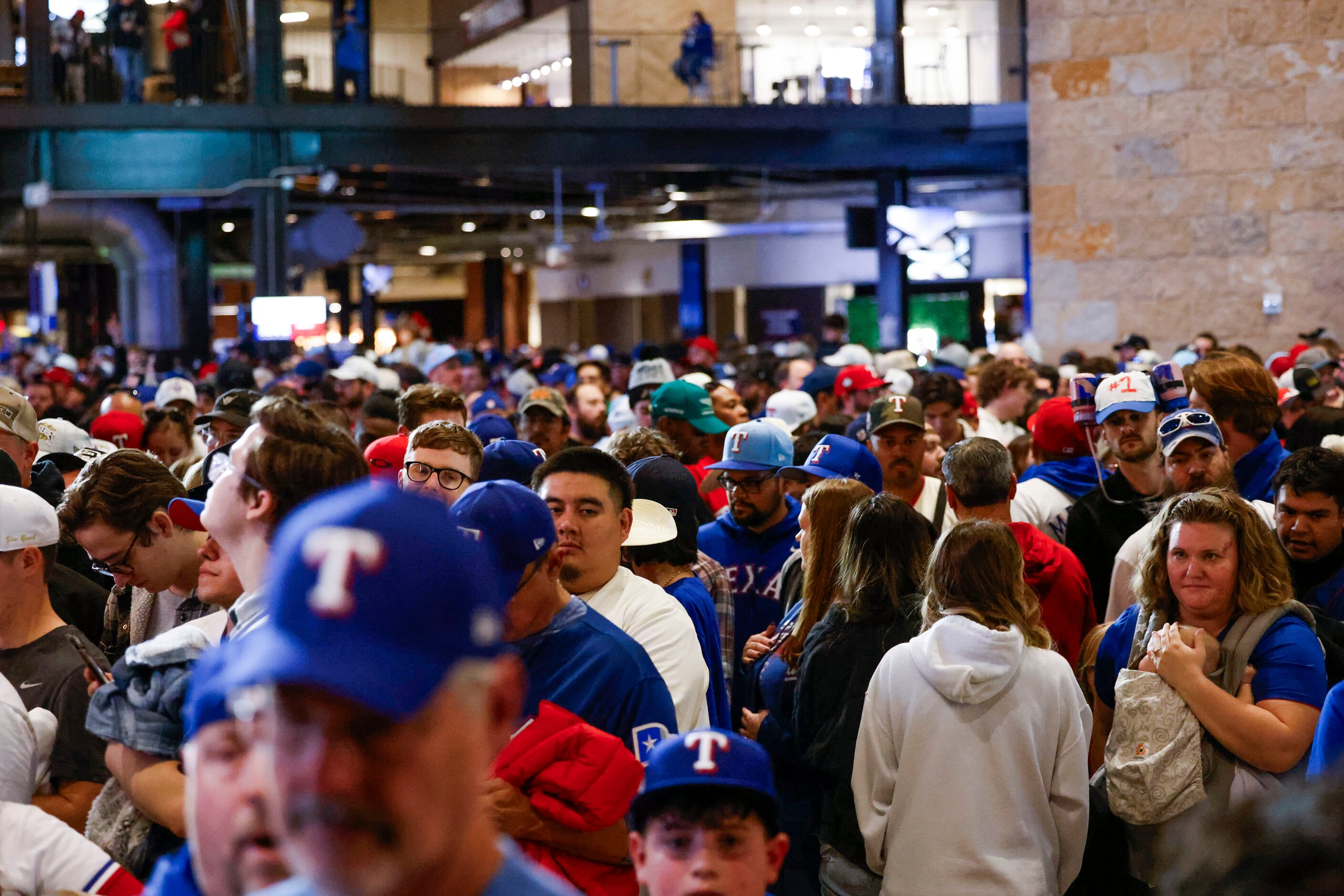 Texas Rangers fans wait in line to buy World Series merchandise following Texas Rangers’...