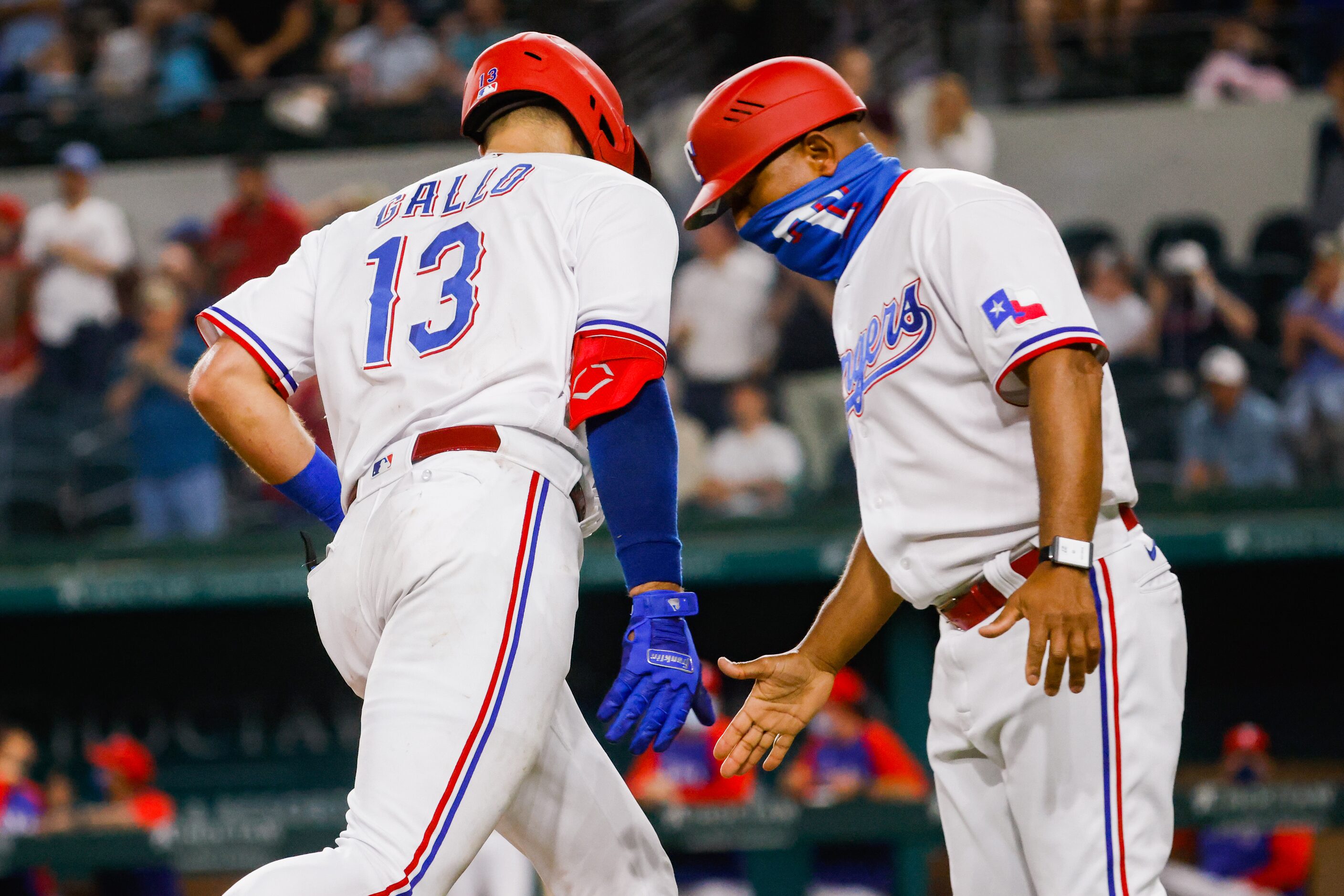 Texas Rangers center fielder Joey Gallo (13) high-fives Texas Rangers third base coach Tony...