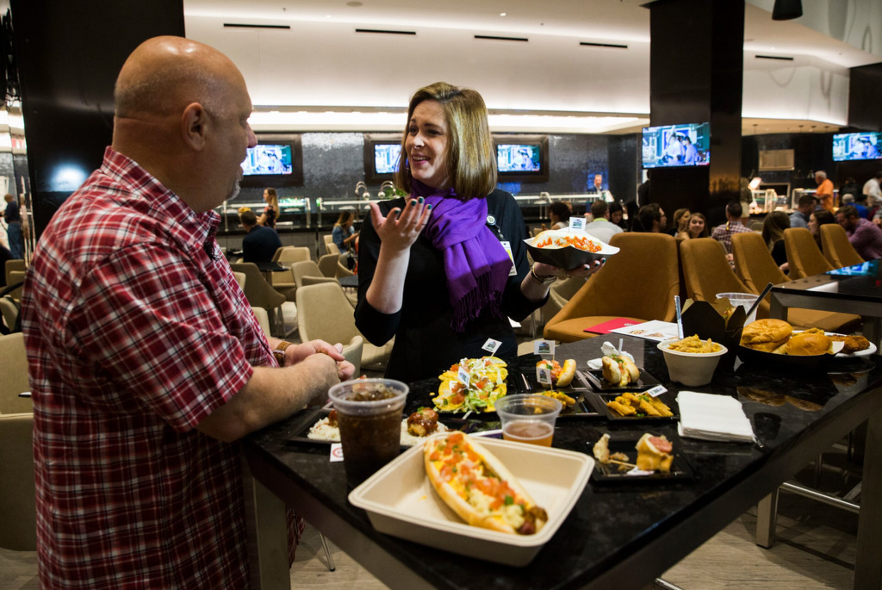 The Dallas Morning News' Evan Grant and Sarah Blaskovich sample new concession stand items...