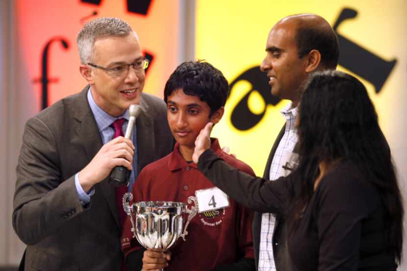 Chetan Reddy, 13, is congratulated by his mother, Geetha Manku, after spelling the winning...