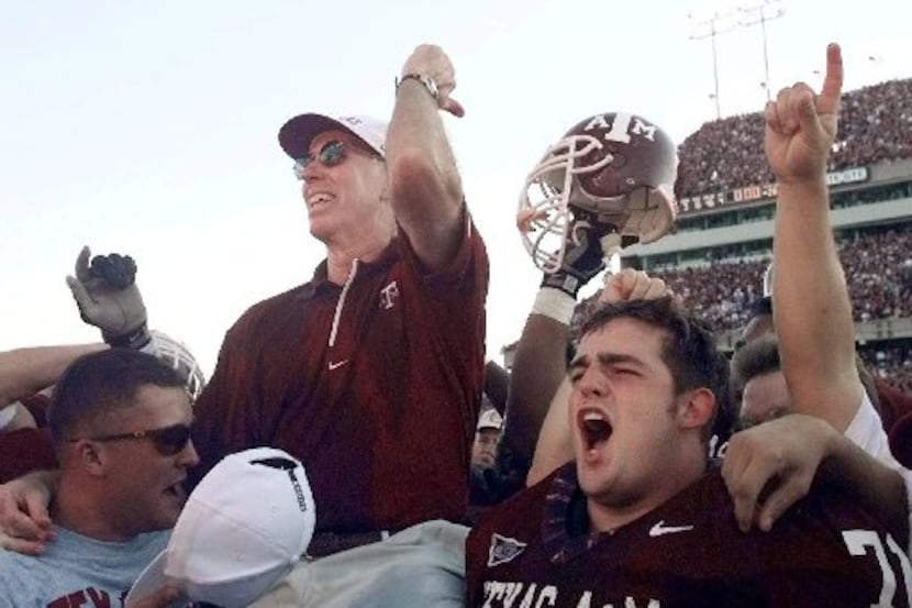 Texas A&M coach R.C. Slocum is lifted to the shoulders of his players after they defeated...