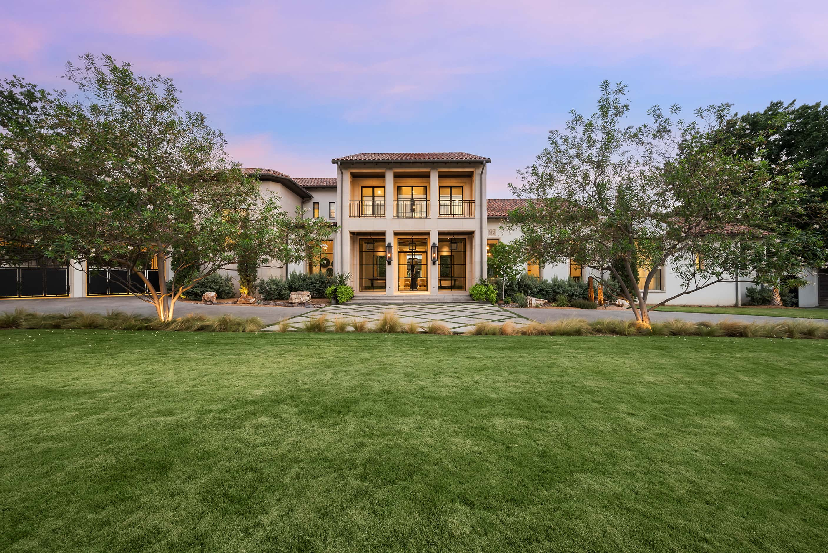 Front exterior of a home with a red tile roof and modern design elements like steel doors.