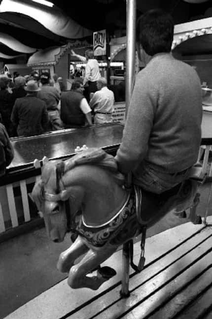 Tom Kuhn of Oakland, Md., sat  on one of the merry-go-round horses inside Penny Whistle Park...