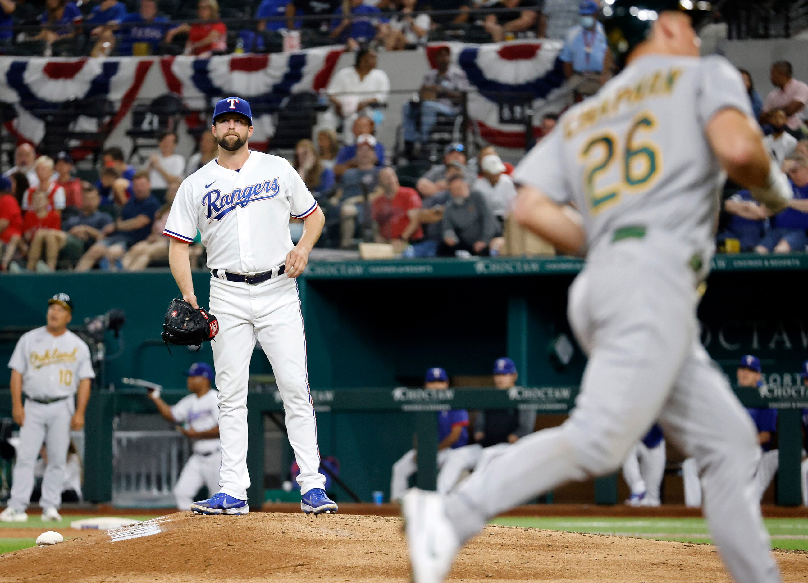 Texas Rangers starting pitcher Jordan Lyles (24) reacts after Oakland Athletics batter Matt...