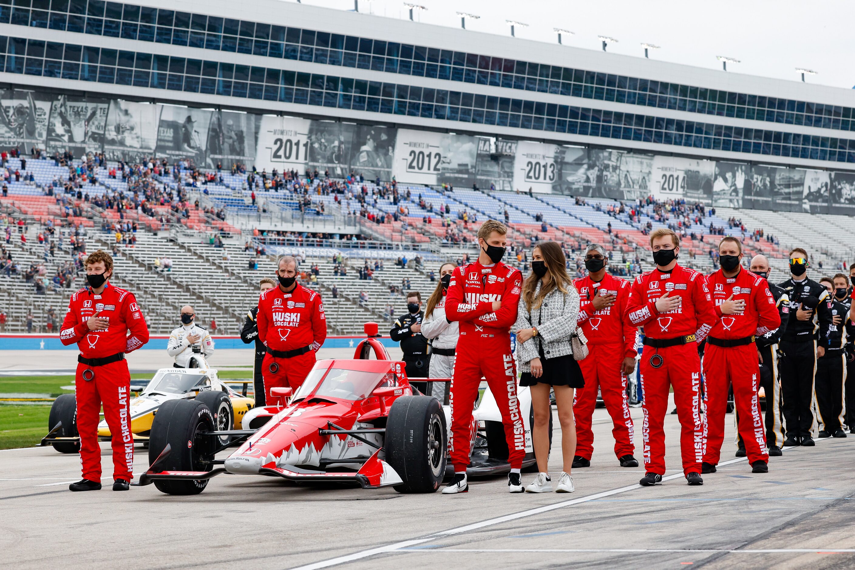 Marcus Ericsson (#8) and his team stand for the national anthem before the start of the...