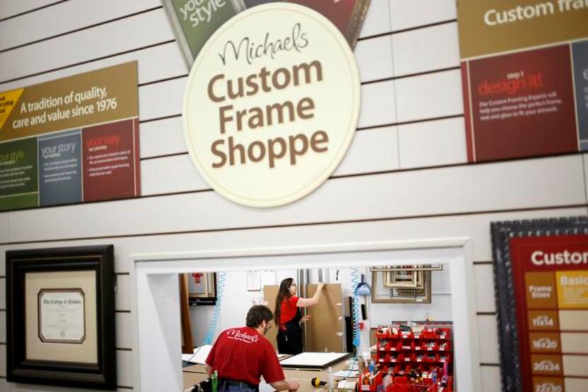 Shoppers chat at a Michaels store in Cincinnati. The company is hoping to replicate the...