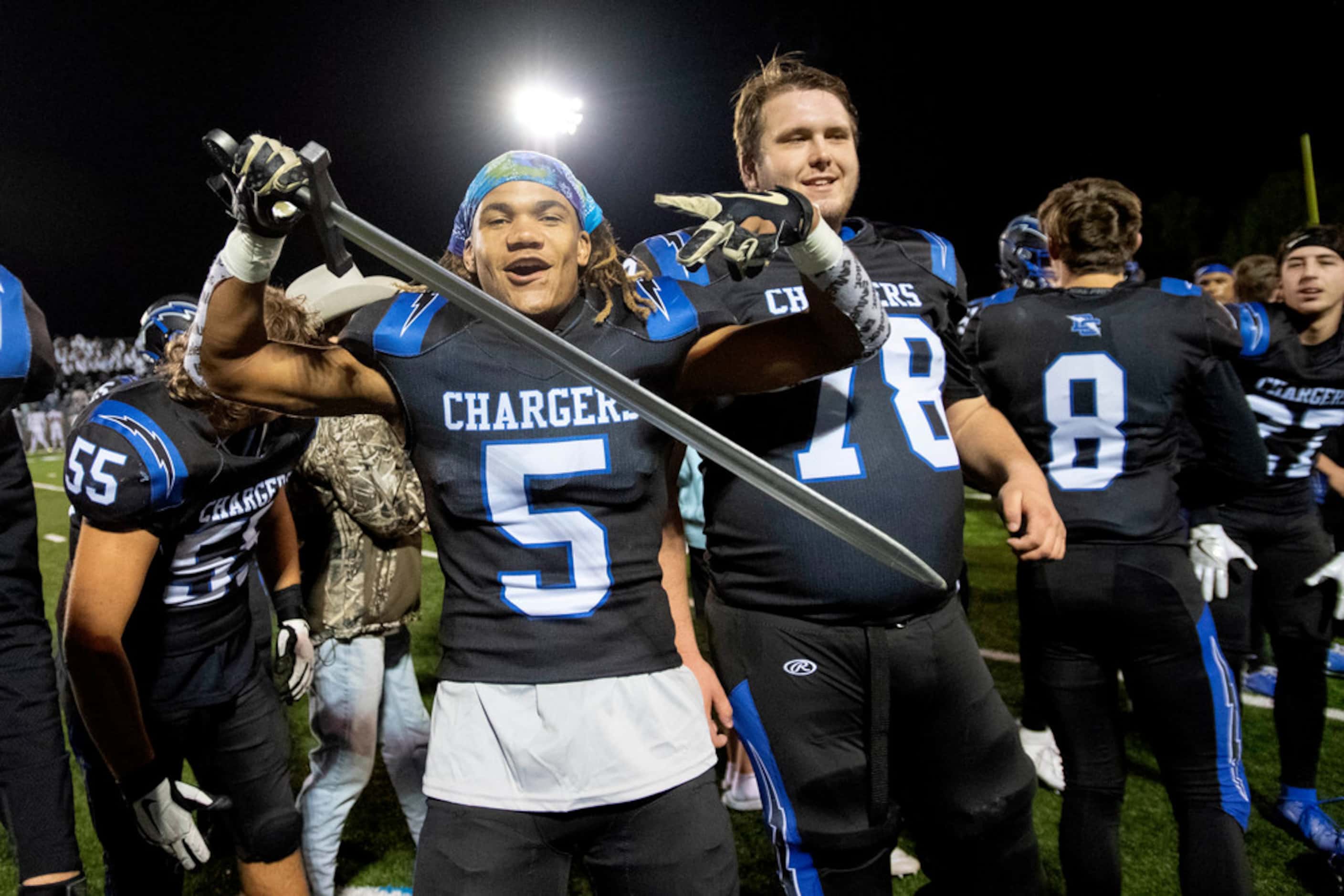 Dallas Christian senior defensive back Peyton Veasley (5) poses with a fake sword after his...