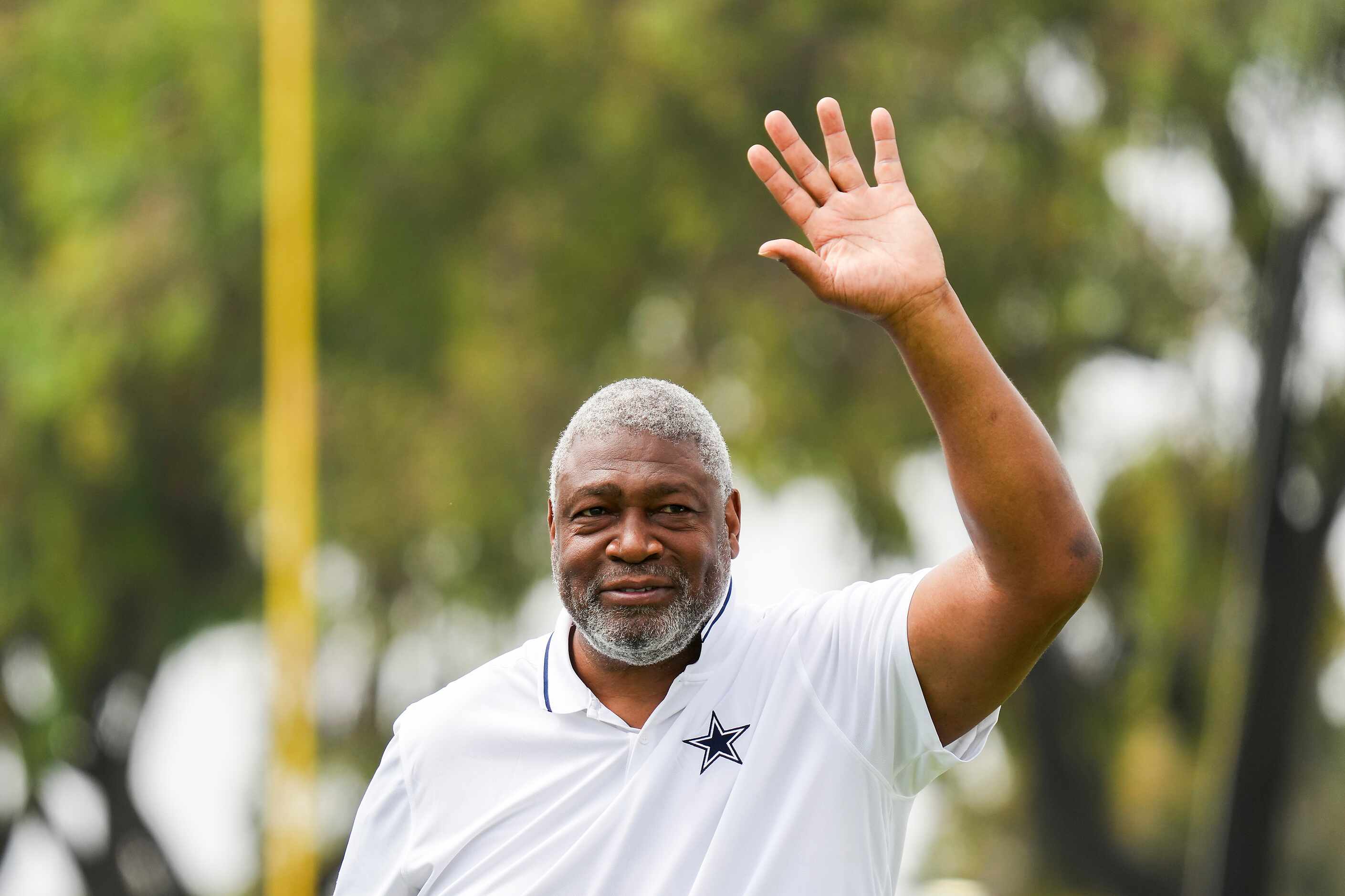 Former Dallas Cowboys player Charles Haley  waves to the crowd during opening ceremonies...