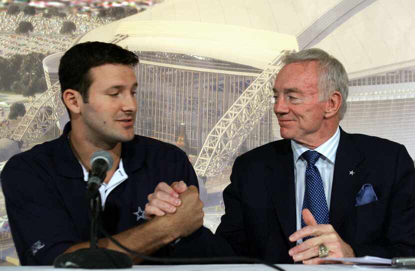 Dallas Cowboys quarterback Tony Romo, left, shakes hands with team owner Jerry Jones during...