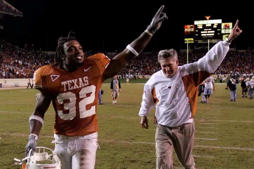 11/6/04 - Austin, Texas -  Texas running back Cedric Benson (32) and head coach Mack Brown...