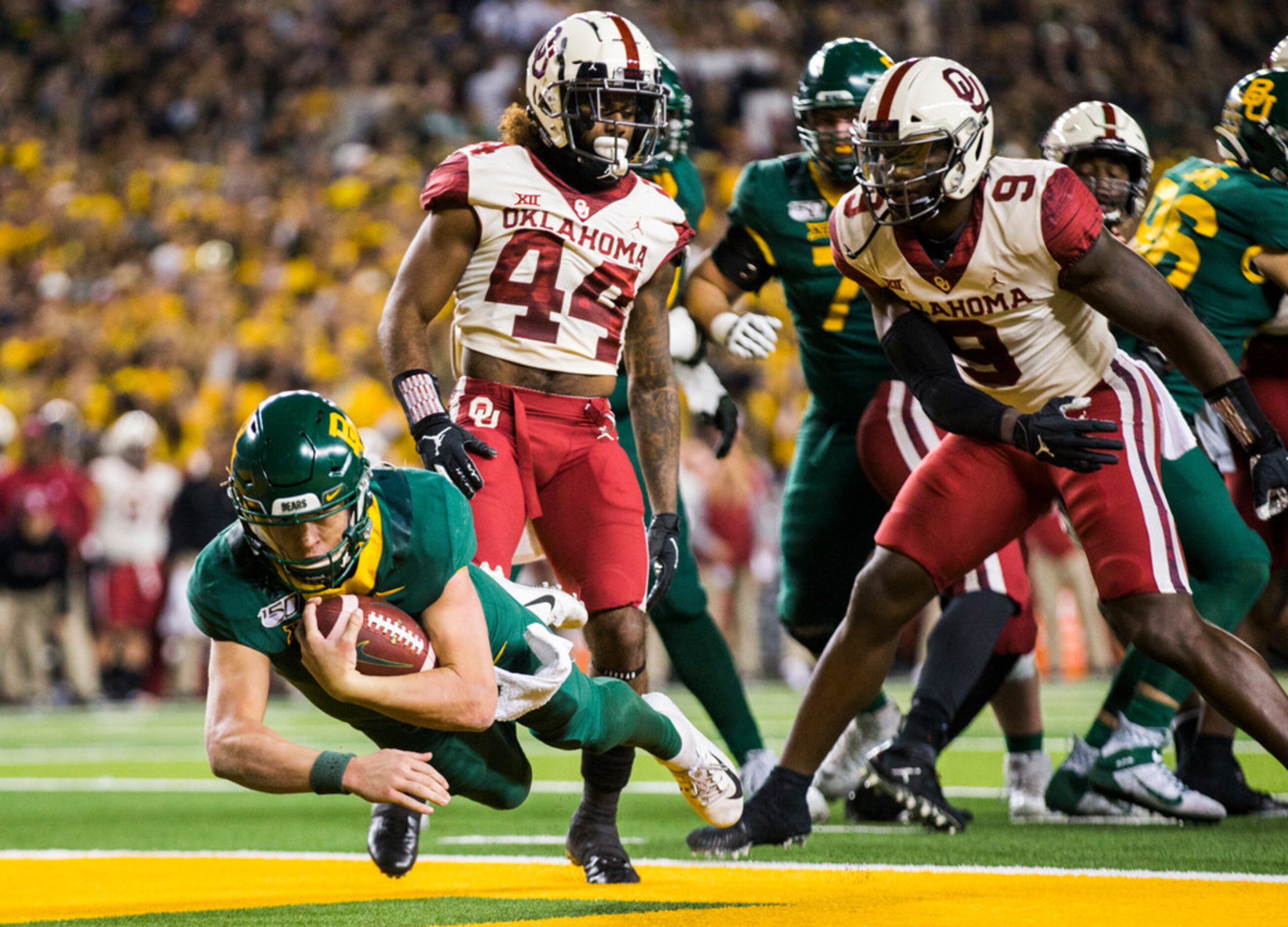 Baylor Bears quarterback Charlie Brewer (12) dives across the goal line for a touchdown...