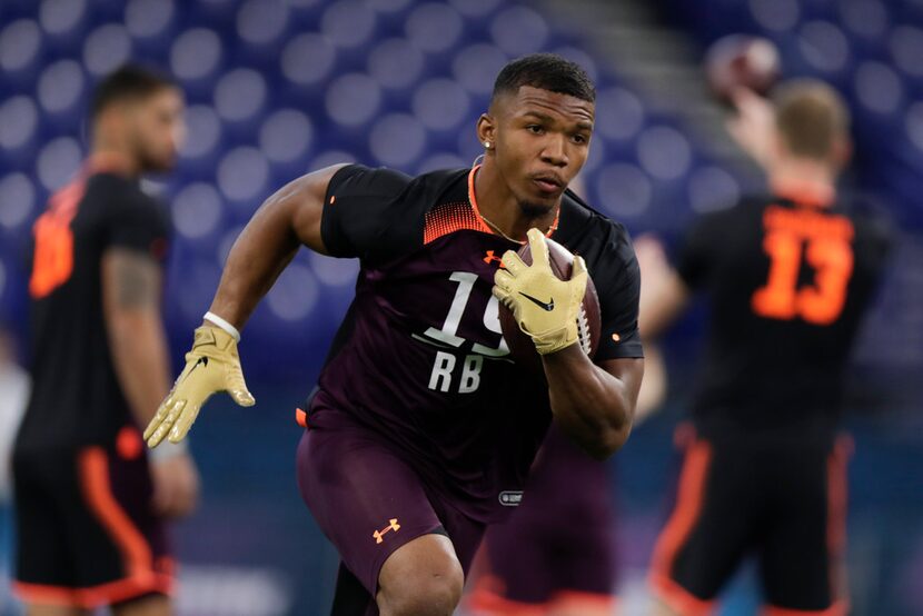 Memphis running back Tony Pollard runs a drill at the NFL football scouting combine in...