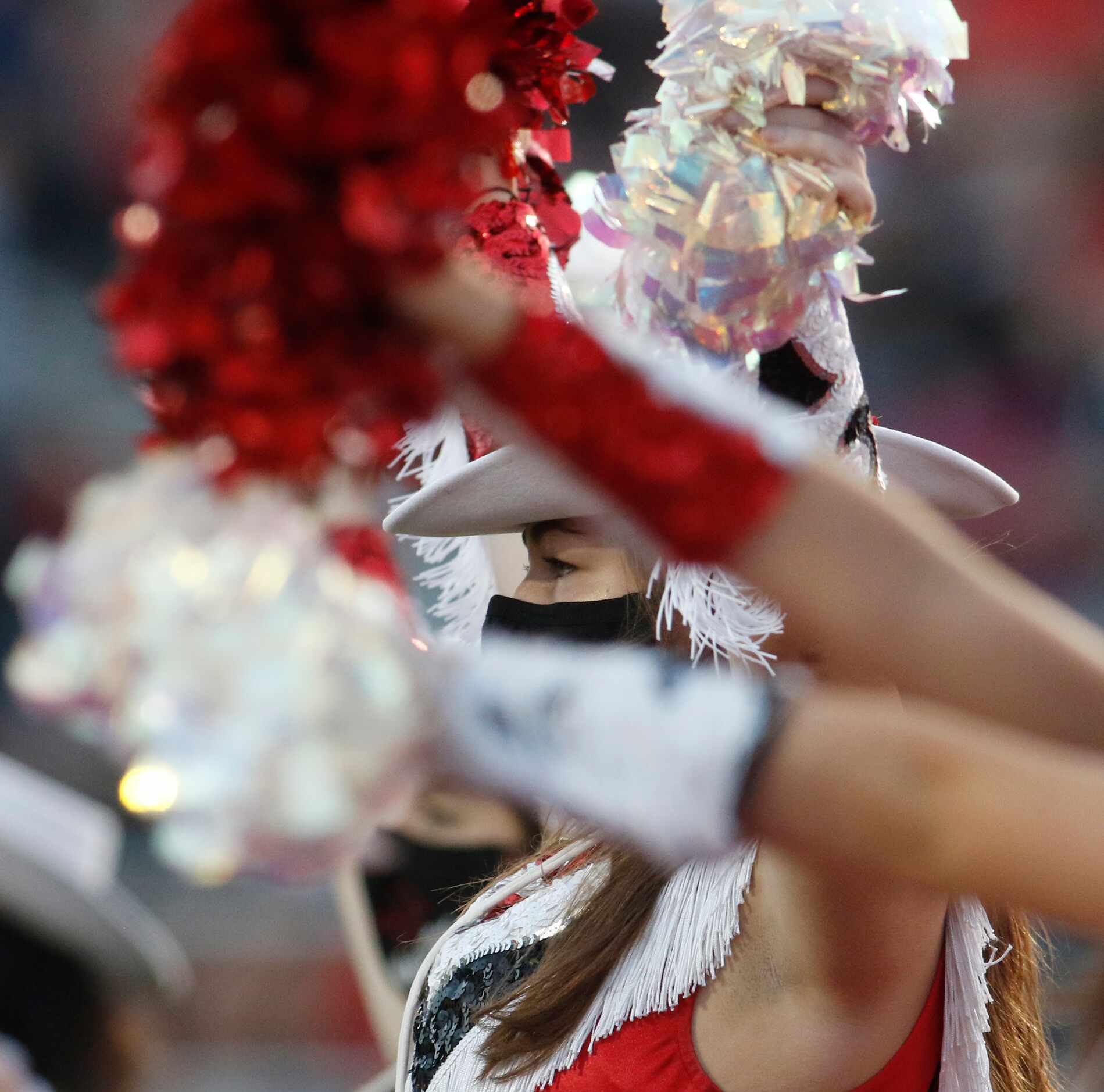 An Argyle drill team member is framed by others as they performed on the field prior to the...